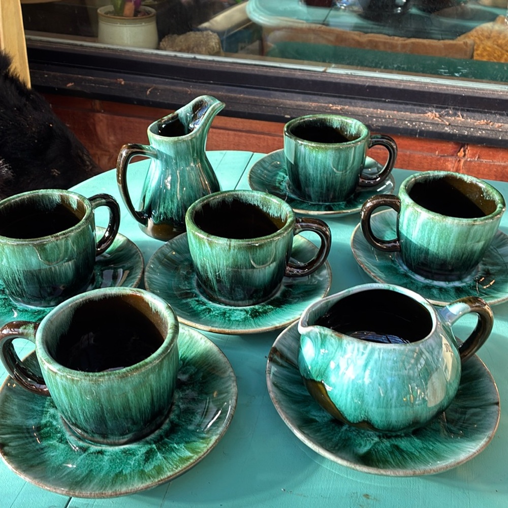 Blue mountain tea cups with two different shapes creamers.